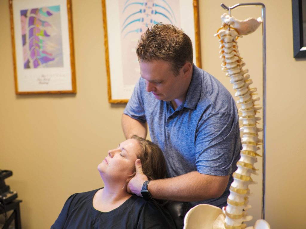 Dr. Homer at Targeted Chiropractic in Gilbert, AZ preforming a neck adjustment.